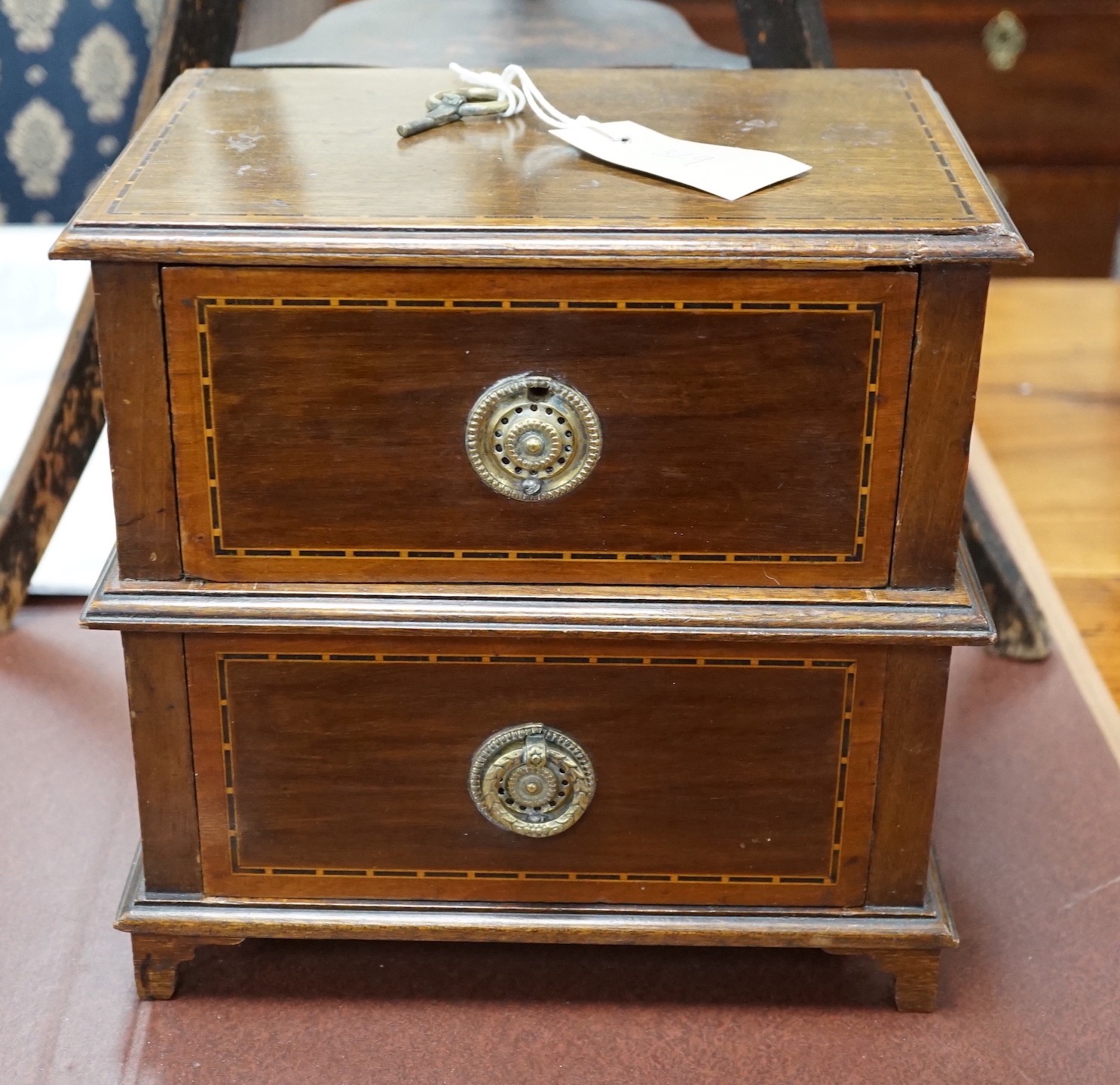 An Edwardian ebonised jardiniere stand with brass liner, width 46cm, depth 46cm, height 85cm, and a miniature two drawer chest *Please note the sale commences at 9am.